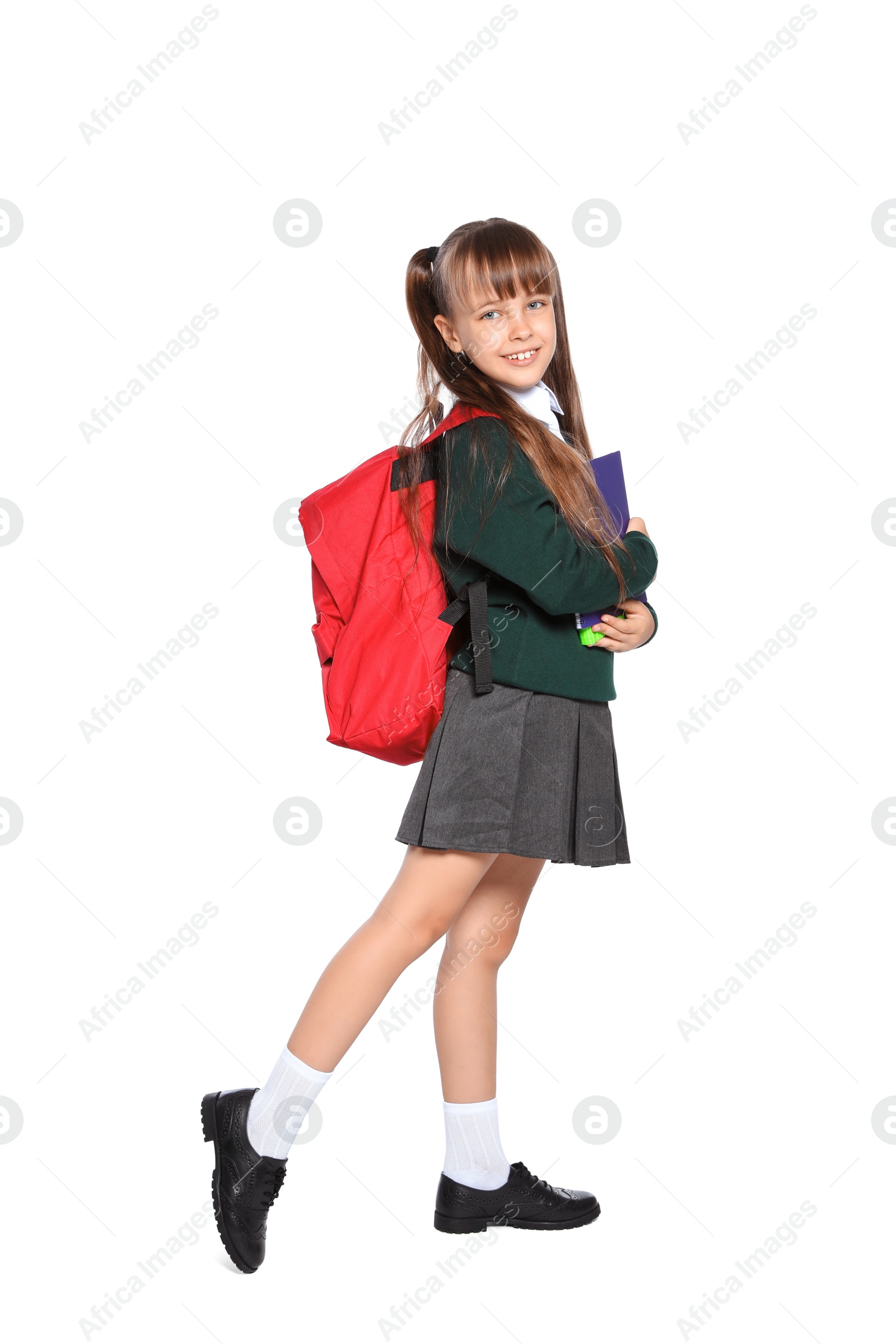 Photo of Little girl in stylish school uniform on white background