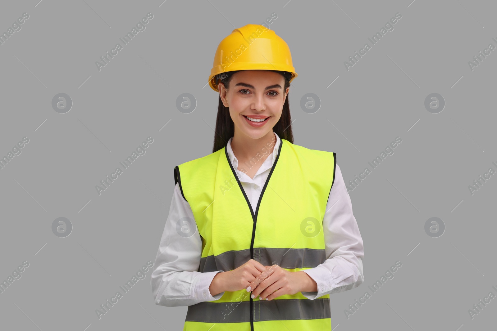 Photo of Engineer in hard hat on grey background