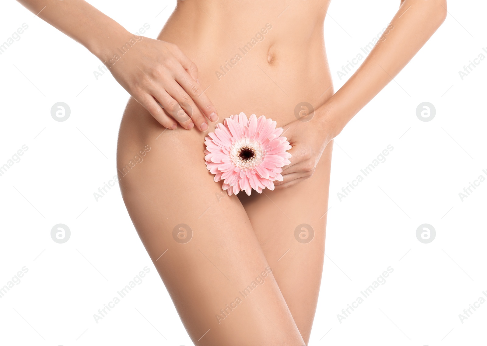 Photo of Woman with flower showing smooth skin after Brazilian bikini epilation on white background, closeup. Body care concept