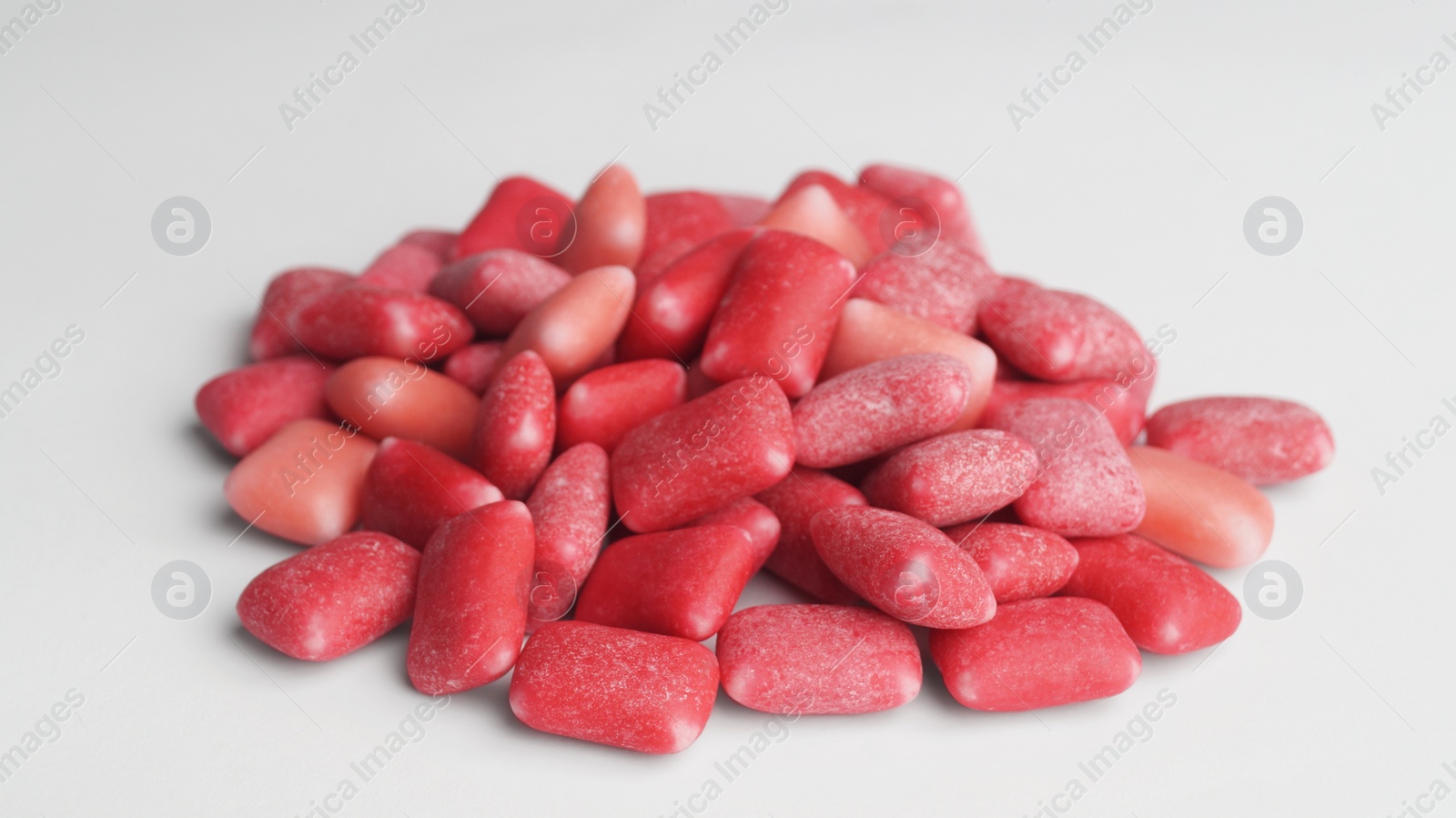 Photo of Pile of sweet chewing gums on white background