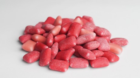 Photo of Pile of sweet chewing gums on white background