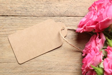 Happy Mother's Day. Beautiful flowers and blank card on wooden table, top view