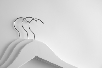 Empty clothes hangers on white background, top view