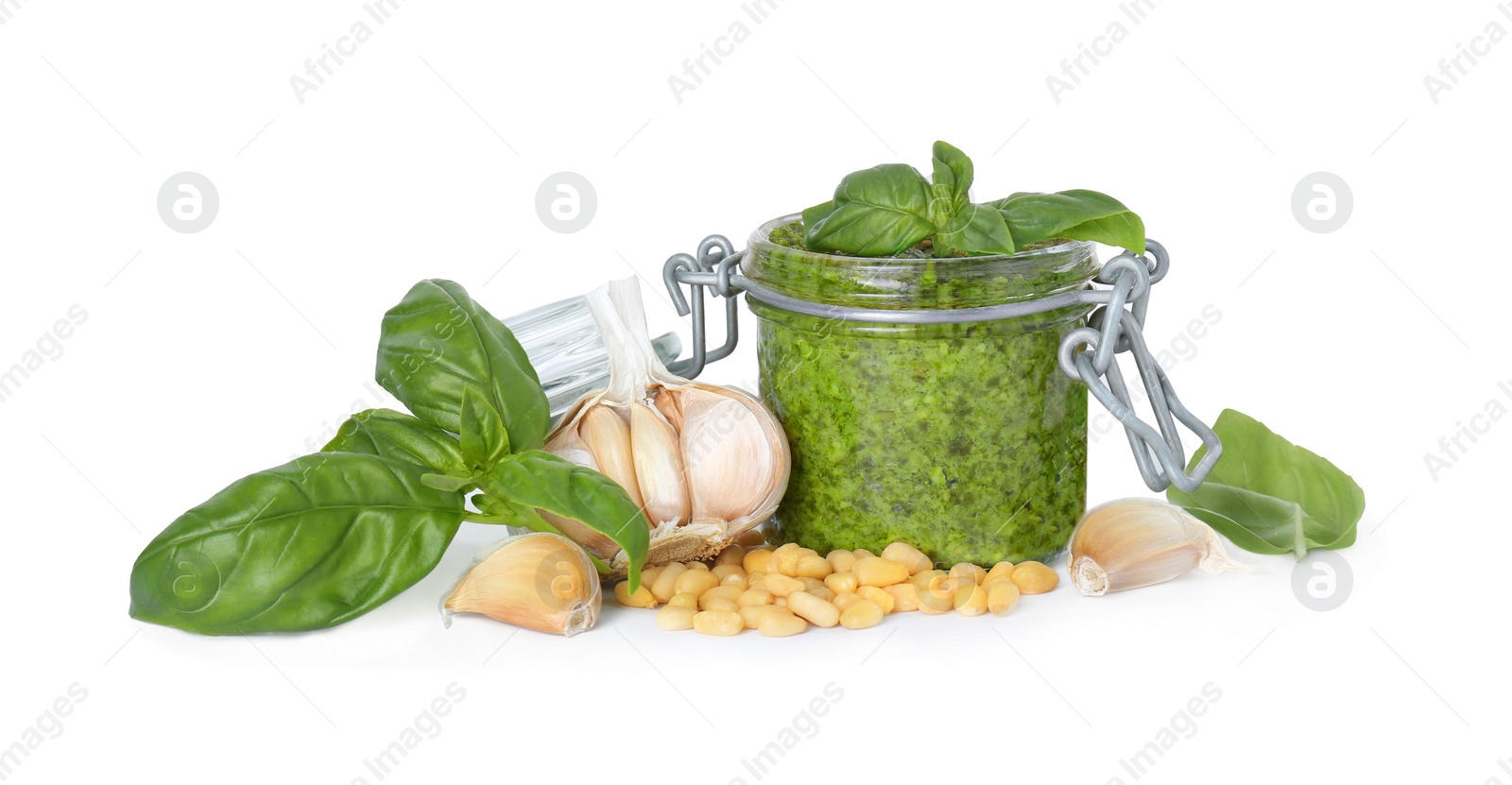 Photo of Delicious pesto sauce in jar and ingredients isolated on white