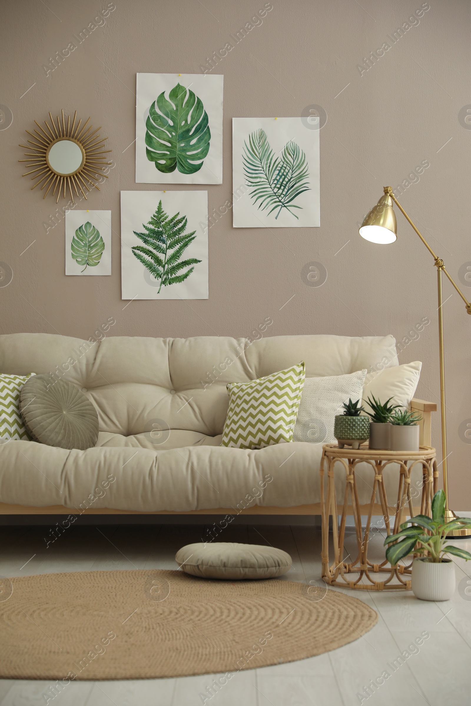 Photo of Stylish living room interior with comfortable sofa and beautiful pictures on wall