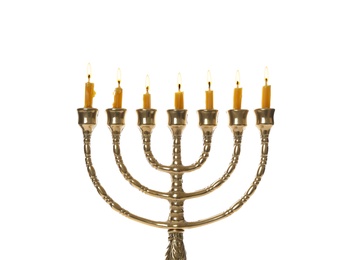 Photo of Golden menorah with burning candles on white background