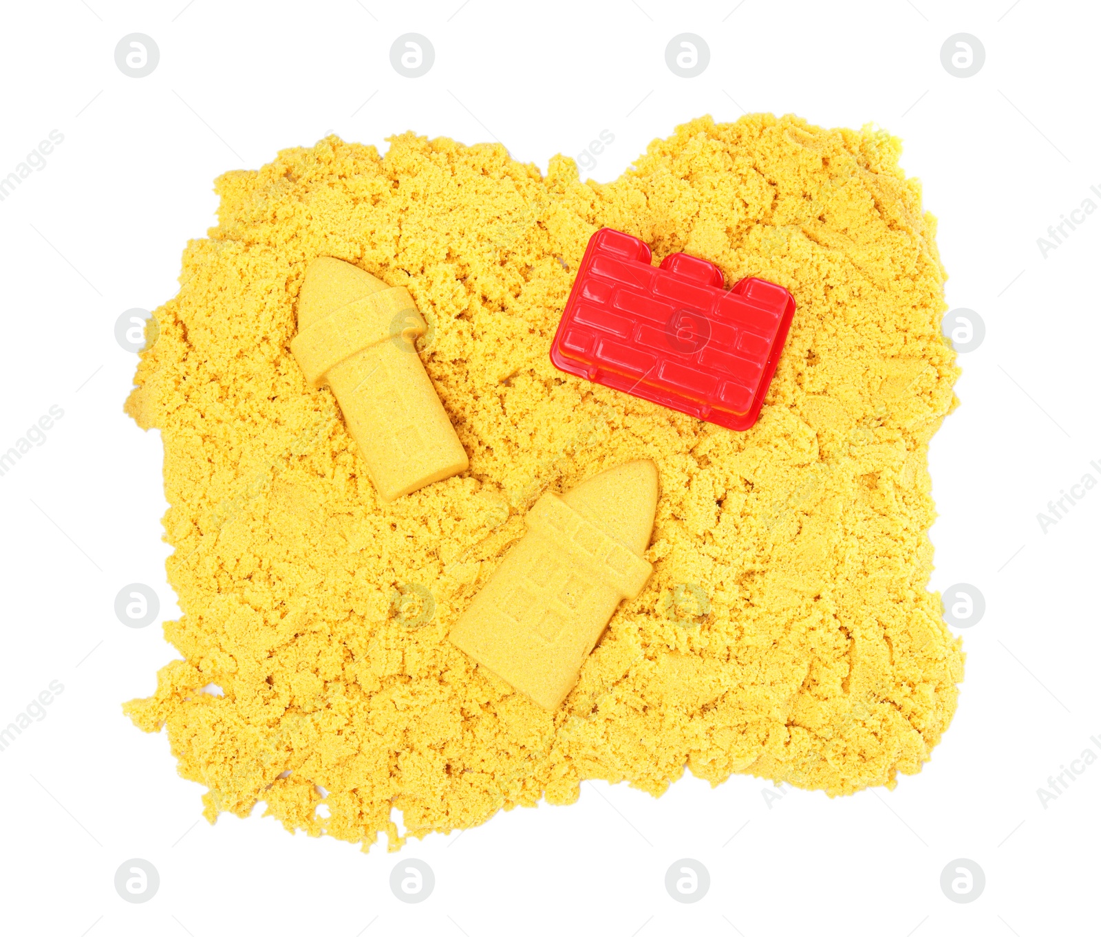 Photo of Yellow kinetic sand and toy on white background, top view