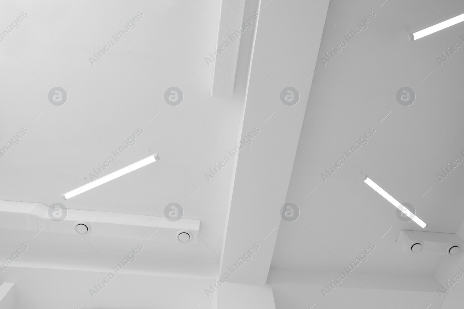 Photo of Ceiling with modern lights in room, bottom view