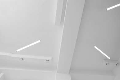 Ceiling with modern lights in room, bottom view