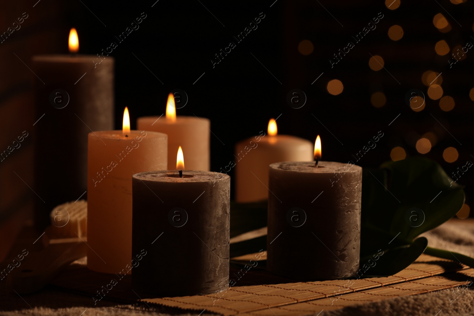 Photo of Spa composition with burning candles on massage table in wellness canter