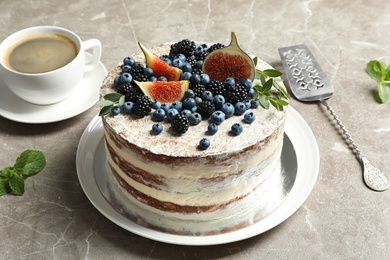Photo of Delicious homemade cake with fresh berries served on table