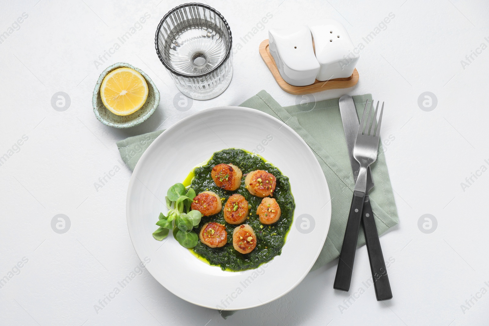 Photo of Delicious fried scallops in bowl served on white table, flat lay