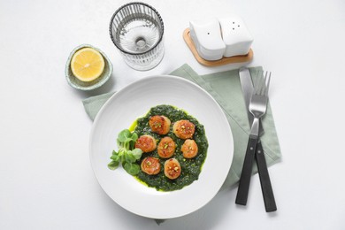 Delicious fried scallops in bowl served on white table, flat lay