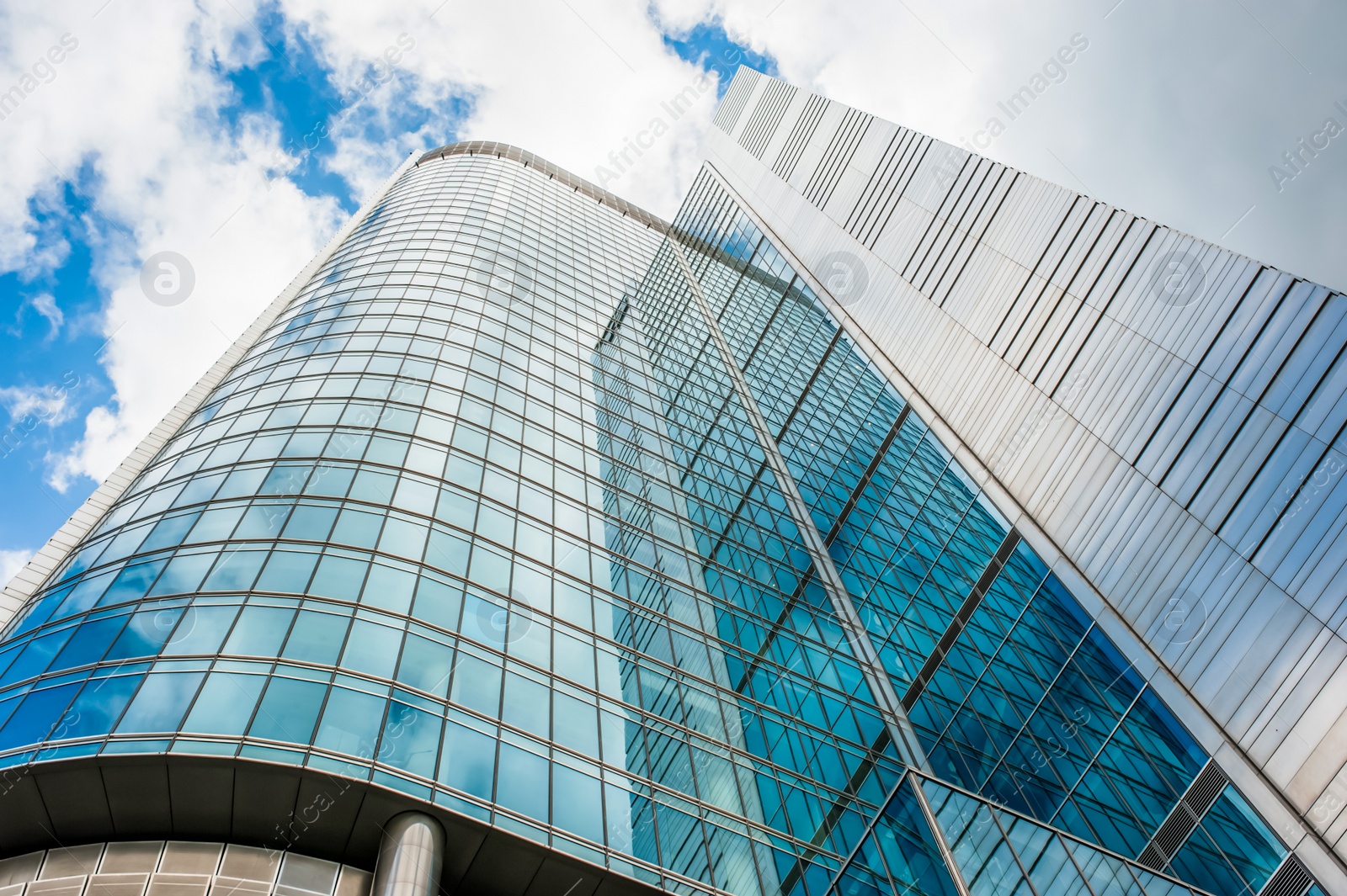 Photo of Beautiful building with many windows under cloudy sky, low angle view