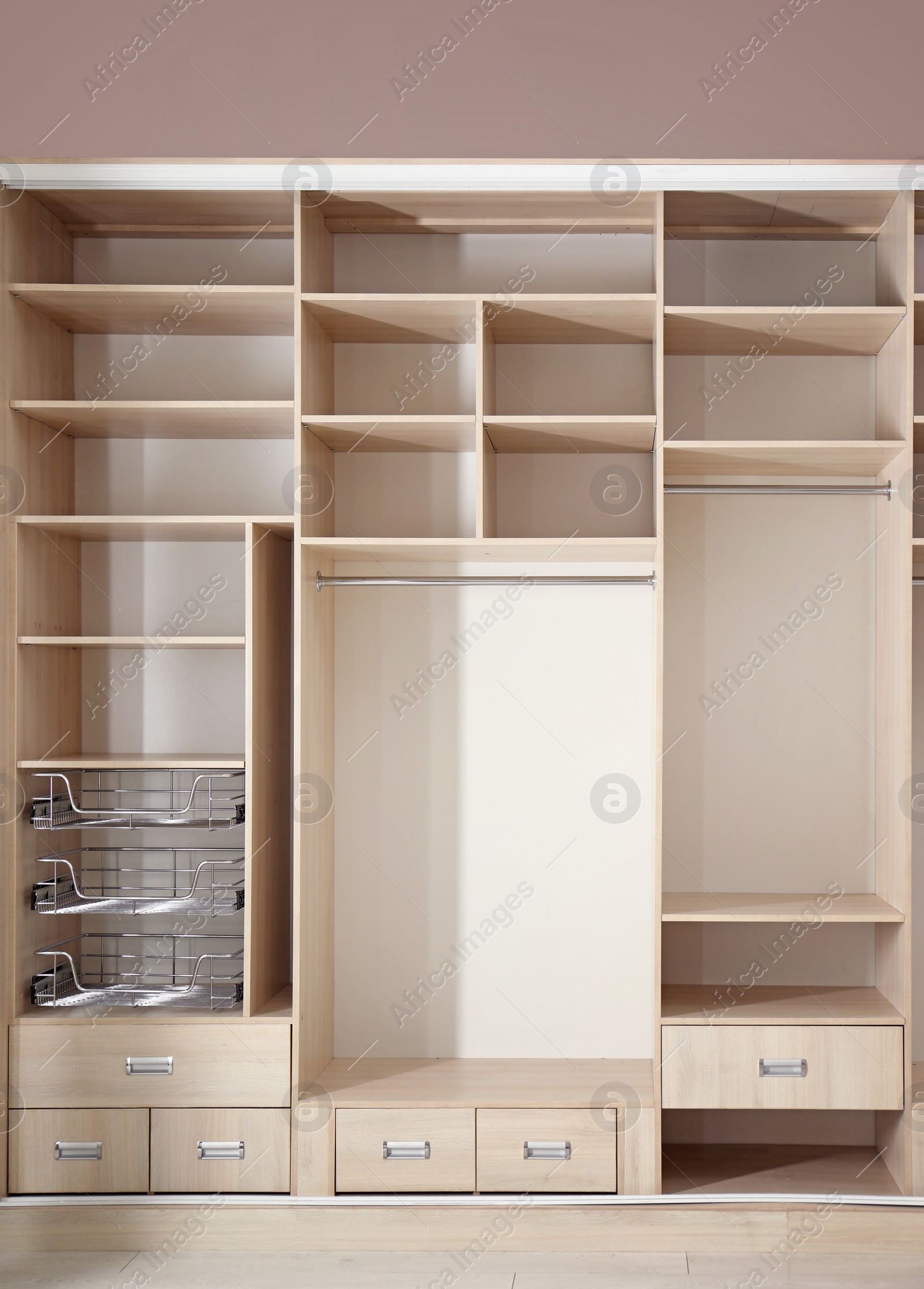 Photo of Empty wardrobe with bags and suitcases on top in dressing room