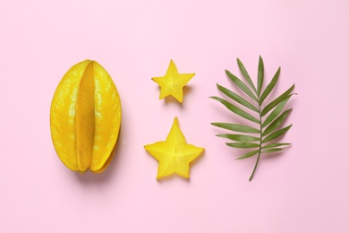 Photo of Delicious carambola fruits on pink background, flat lay