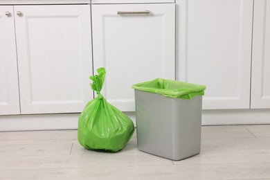 Photo of Plastic garbage bag and trash can in kitchen