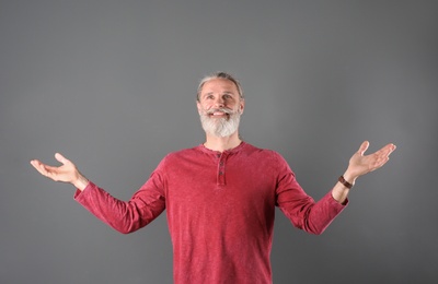 Portrait of handsome mature man on color background