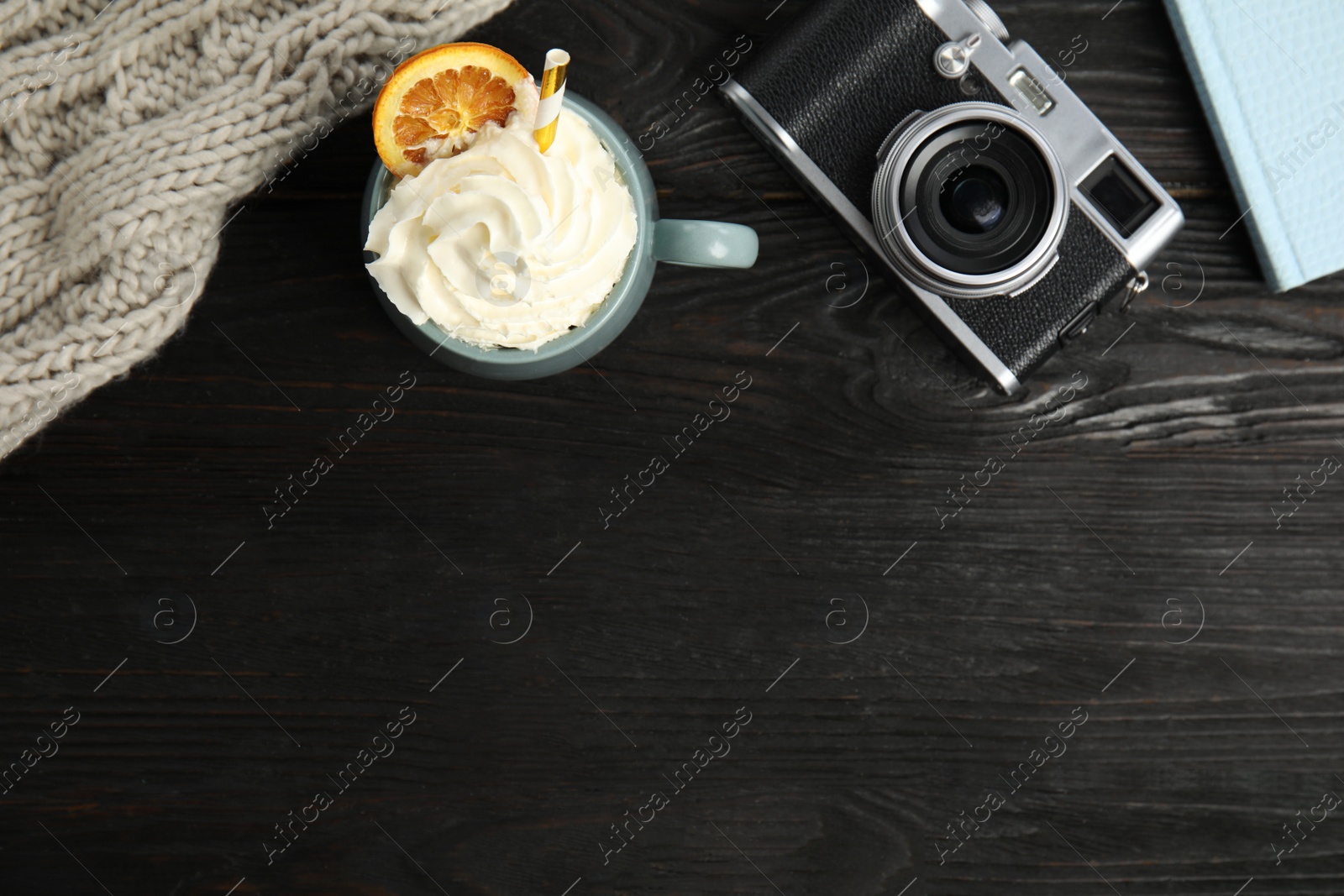 Photo of Cup of hot winter drink on black wooden table, flat lay. Space for text