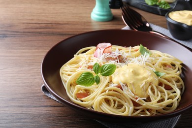 Photo of Delicious spaghetti with cheese sauce and meat on wooden table