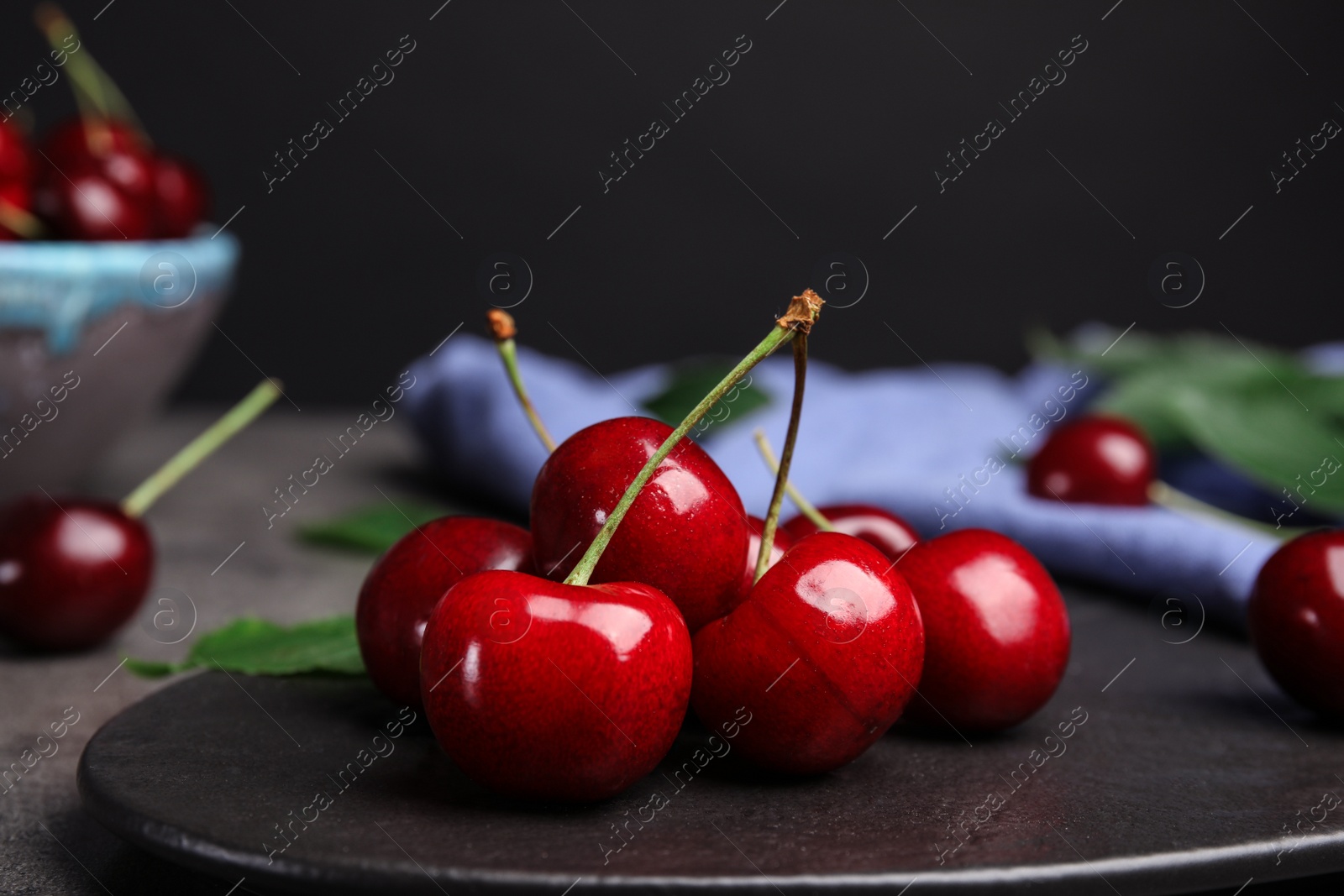 Photo of Board with ripe sweet cherries on table