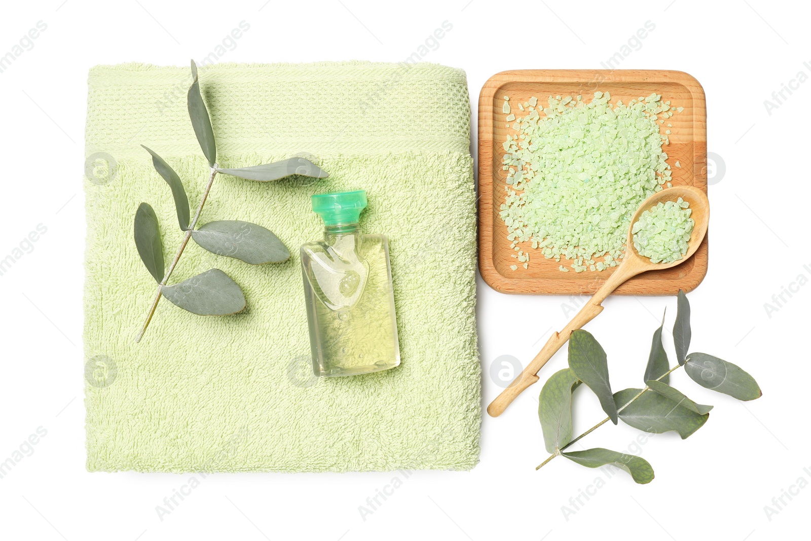 Photo of Green sea salt, cosmetic product, towel and eucalyptus leaves isolated on white, top view