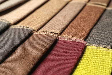 Photo of Fabric samples of different colors for interior design as background