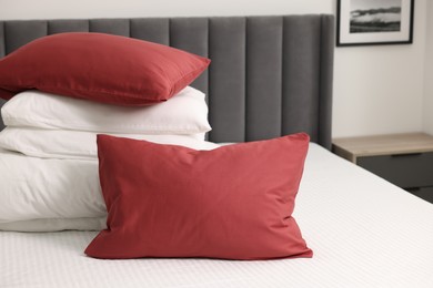 Soft pillows and duvet on bed at home