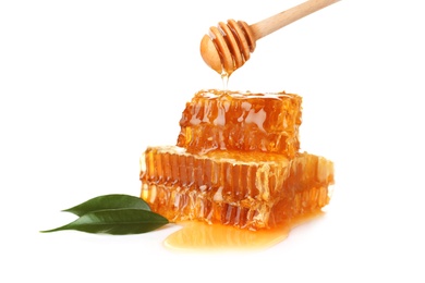 Photo of Pouring honey onto fresh combs on white background