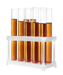 Photo of Test tubes with brown liquid in stand on white background