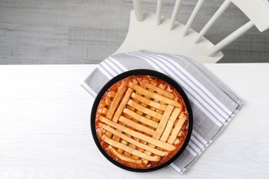 Tasty apricot pie on white wooden table, top view