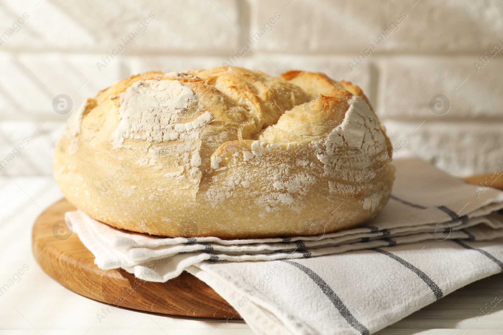 Photo of Freshly baked sourdough bread on white table