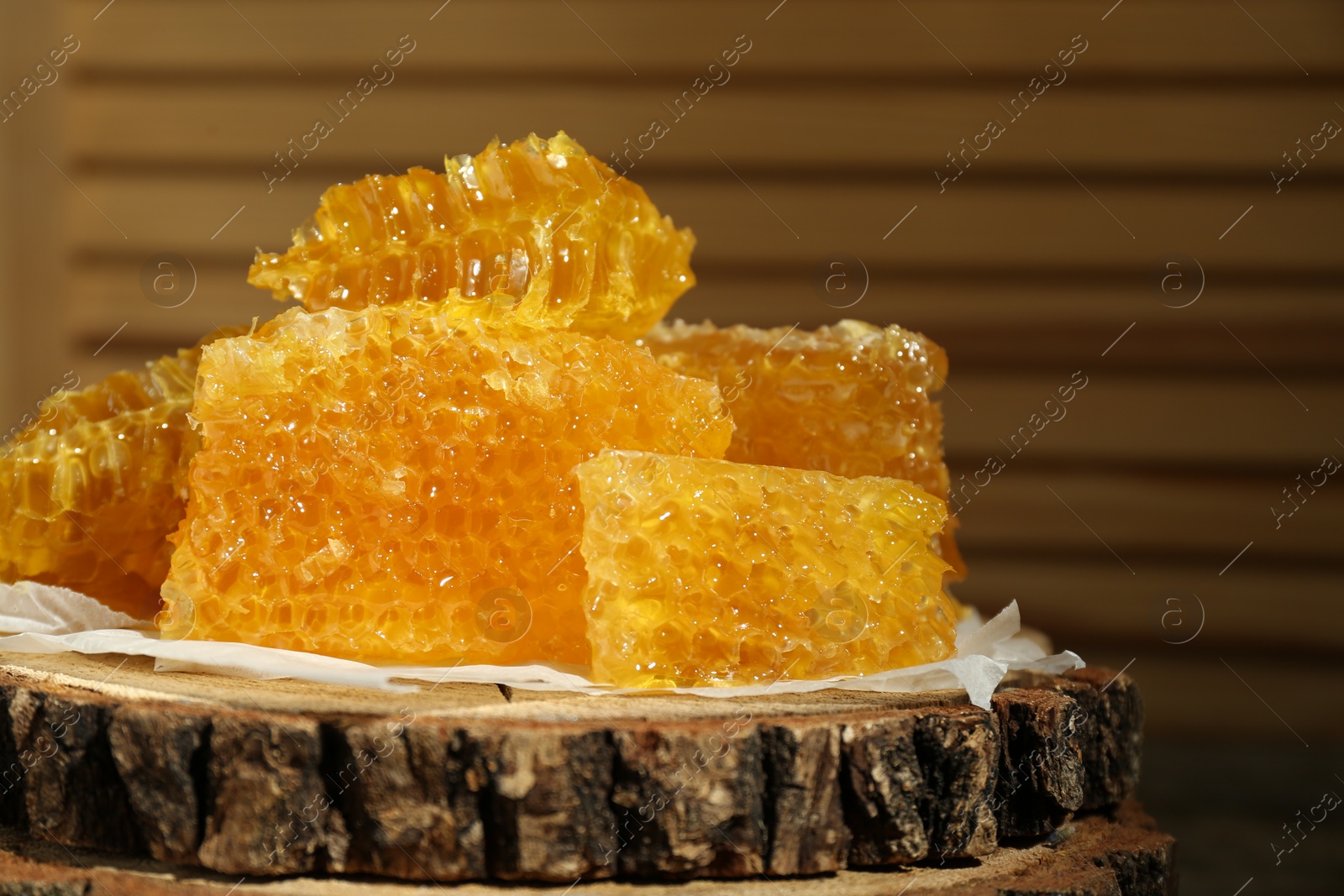 Photo of Natural honeycombs on stump, closeup. Space for text