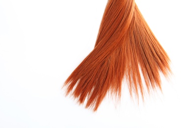 Photo of Beautiful strand of straight red hair on white background, top view. Hairdresser service