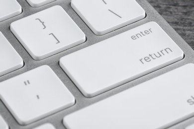 Photo of Modern computer keyboard on table, closeup view