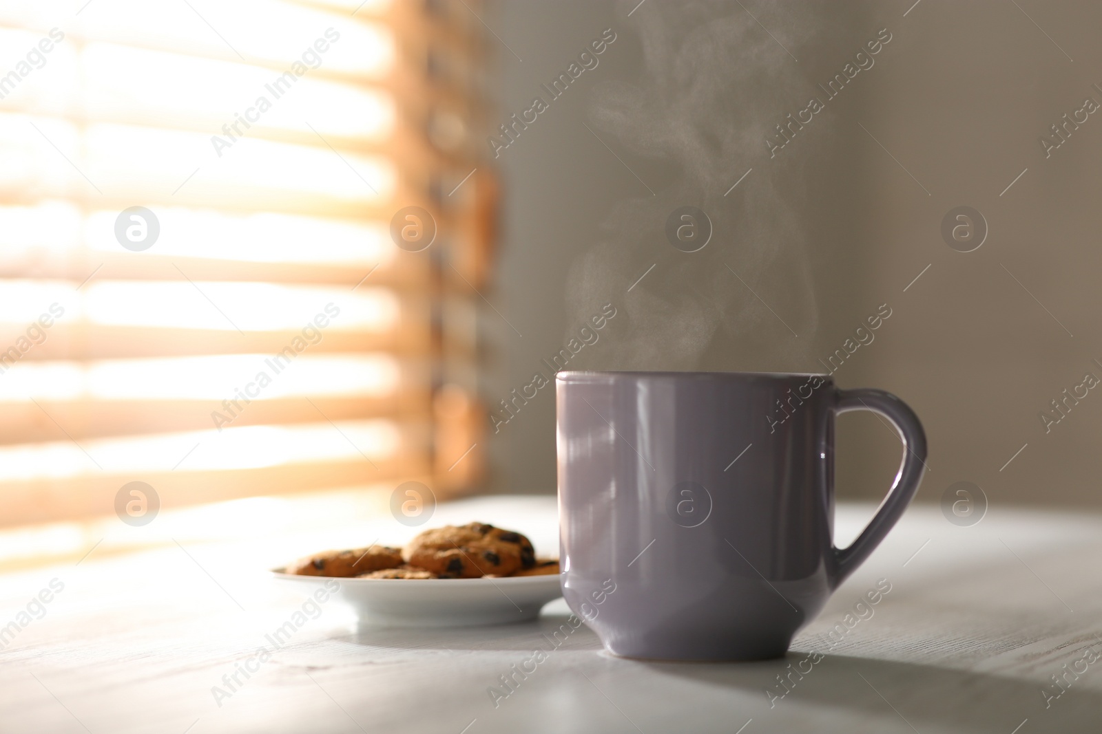 Photo of Tasty coffee and cookies on white wooden table. Good morning