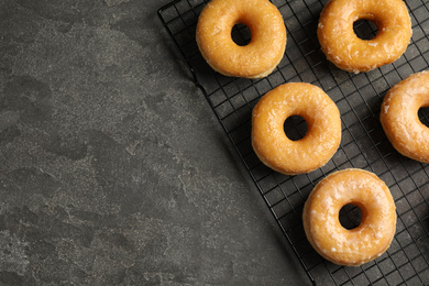 Delicious donuts on grey table, top view. Space for text