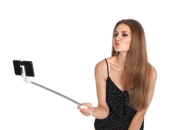 Flirty young woman taking selfie on white background