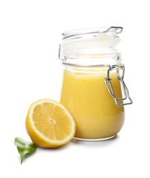 Photo of Delicious lemon curd in glass jar, fresh citrus fruit and green leaf isolated on white