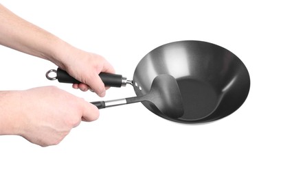 Man holding empty metal wok on white background, closeup