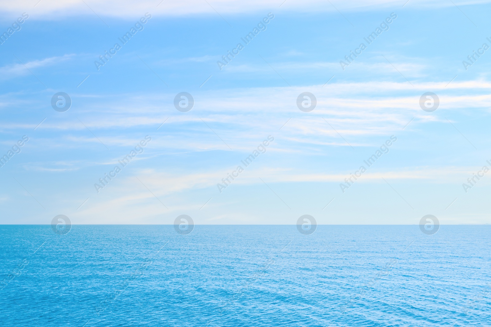 Image of Beautiful ripply sea under blue sky with clouds