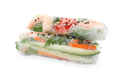 Different rolls wrapped in rice paper on white background, closeup