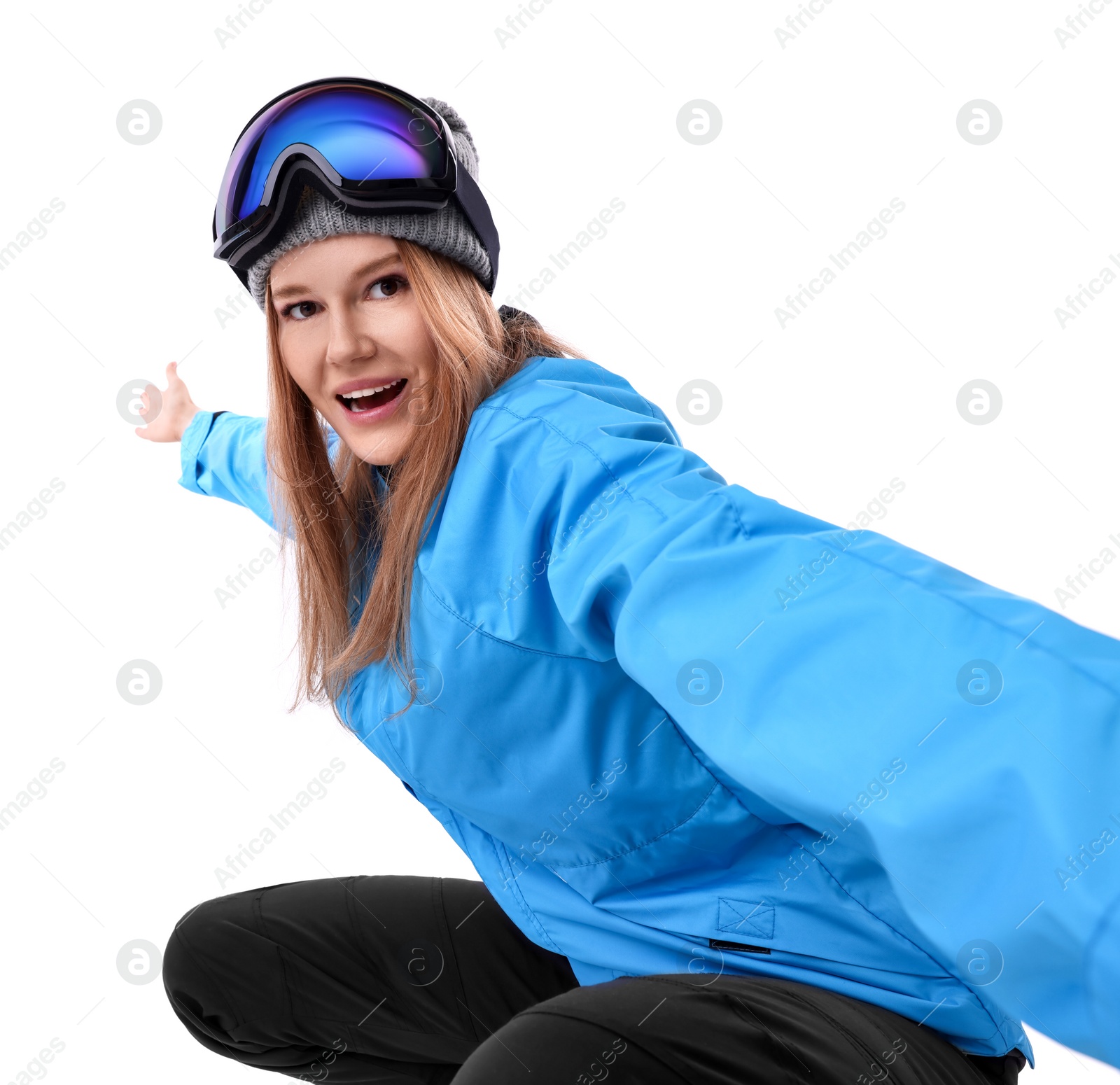 Photo of Beautiful woman in ski goggles taking selfie on white background