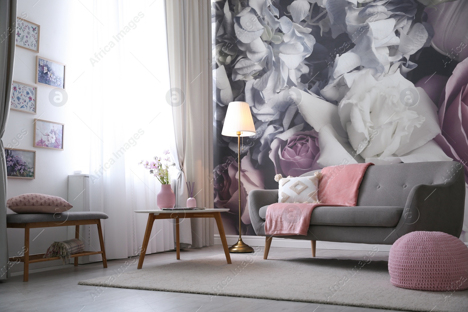 Photo of Living room interior with beautiful artworks on wall near window