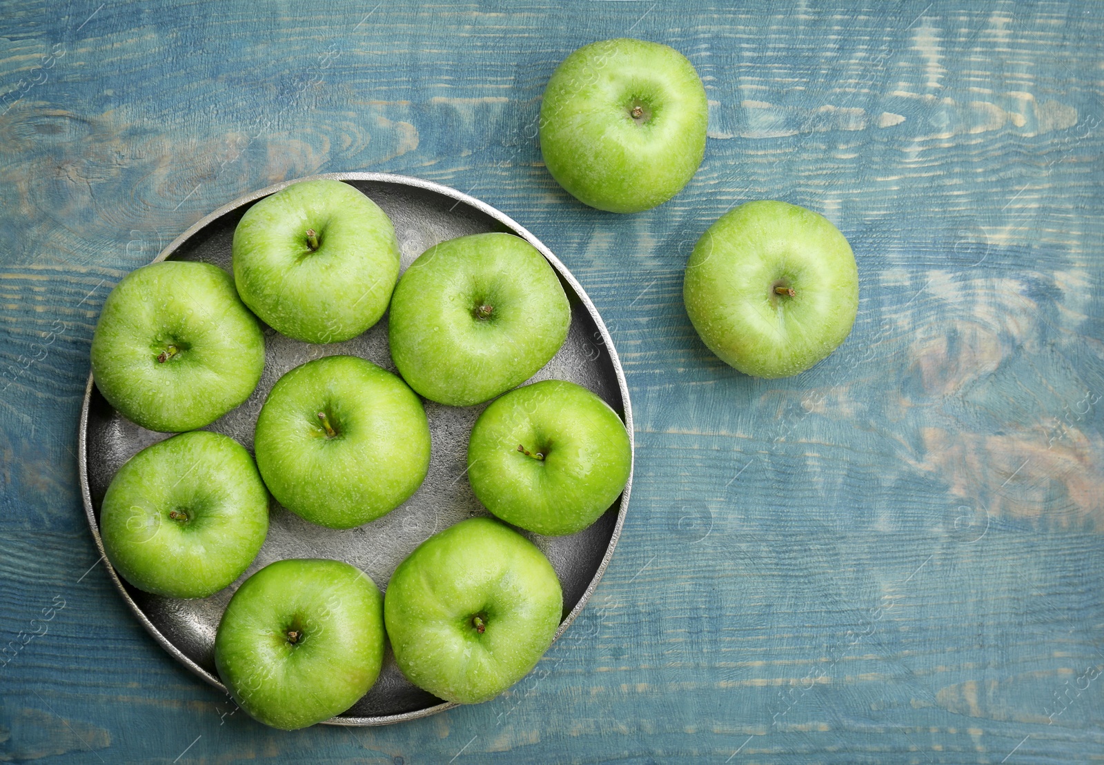 Photo of Plate with fresh green apples on wooden background