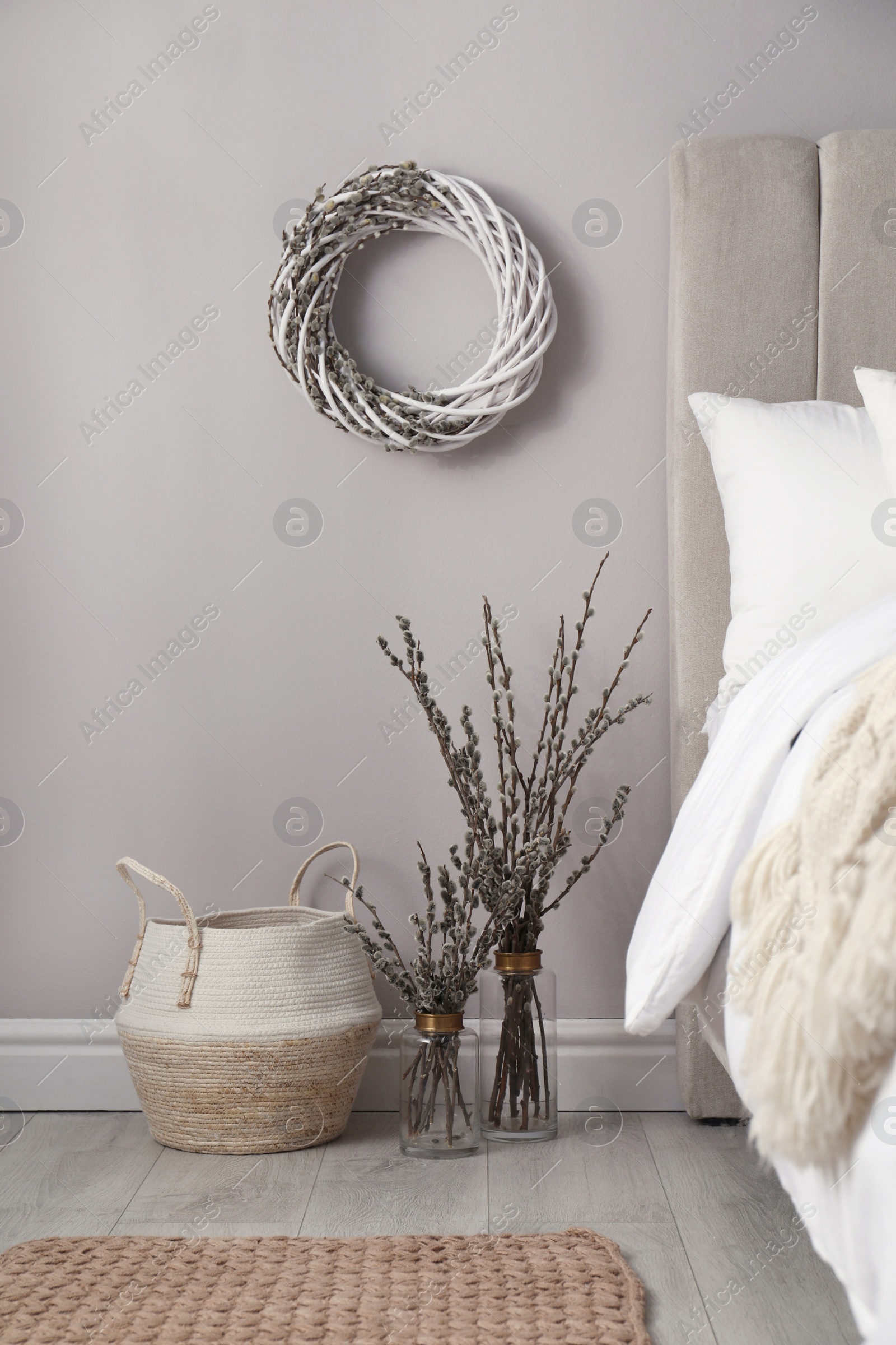 Photo of Bedroom interior with pussy willow branches and other decor