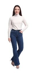 Photo of Young woman in stylish jeans on white background