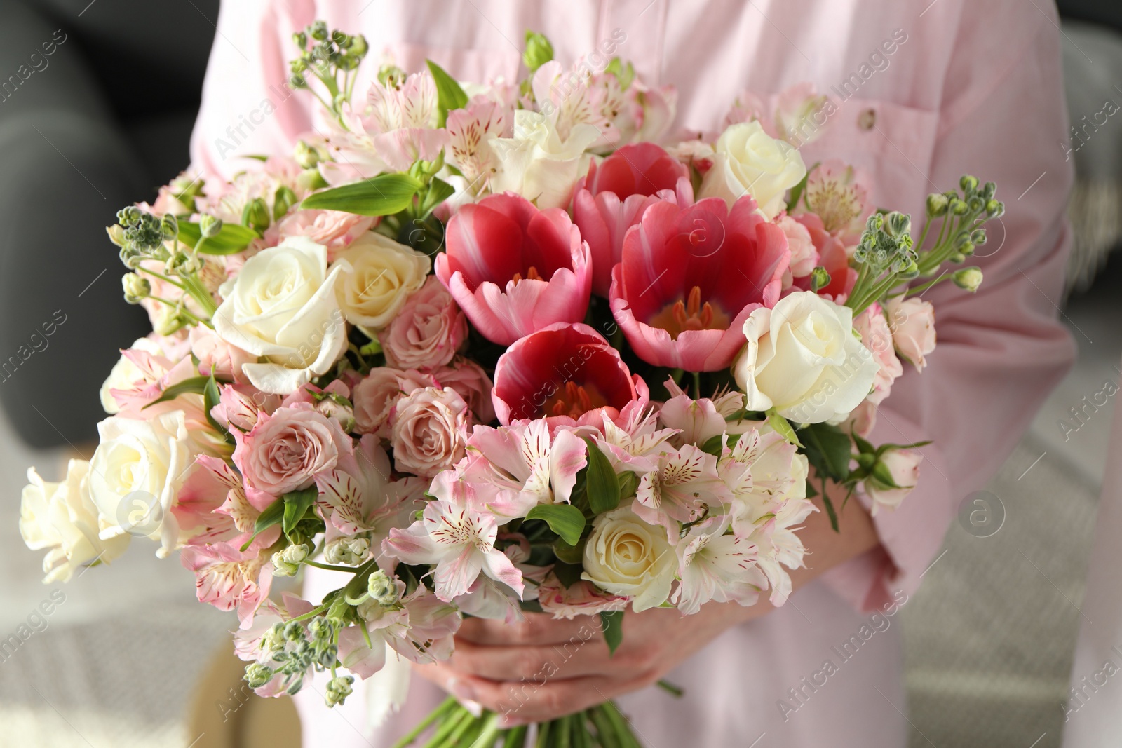 Photo of Woman with beautiful bouquet of fresh flowers indoors, closeup