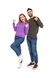 Photo of Happy young people celebrating victory on white background