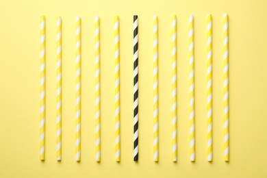 Photo of Collection of straws and different one on yellow background, flat lay